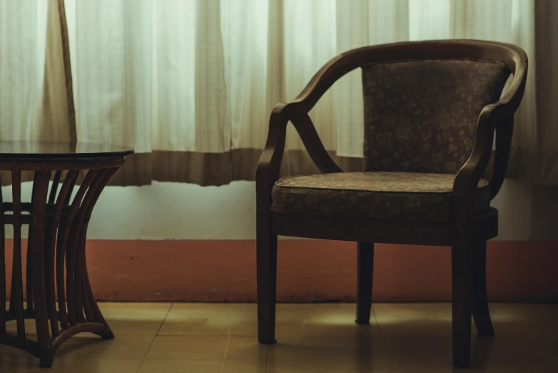 a small wooden table with a chair and a lamp