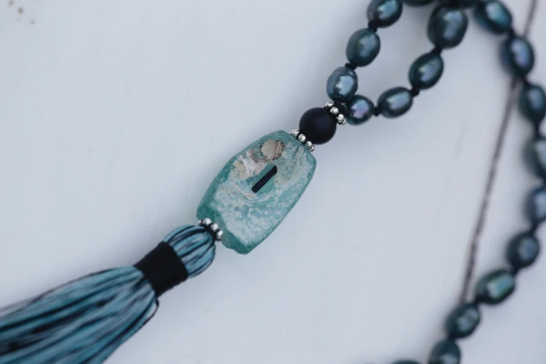 necklace made from an agate jade, blue tassel, and beads