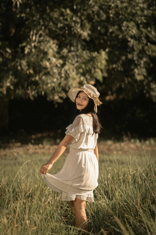 a little girl standing on a grass field