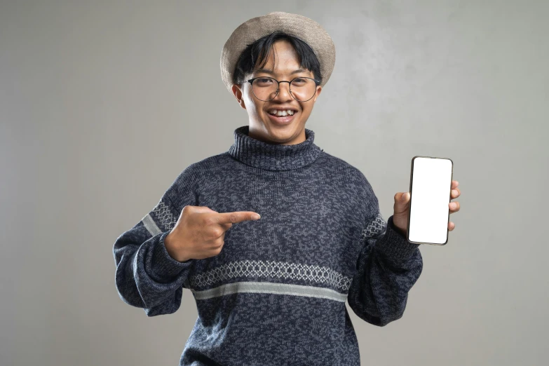 a man holding a smart phone and pointing at soing