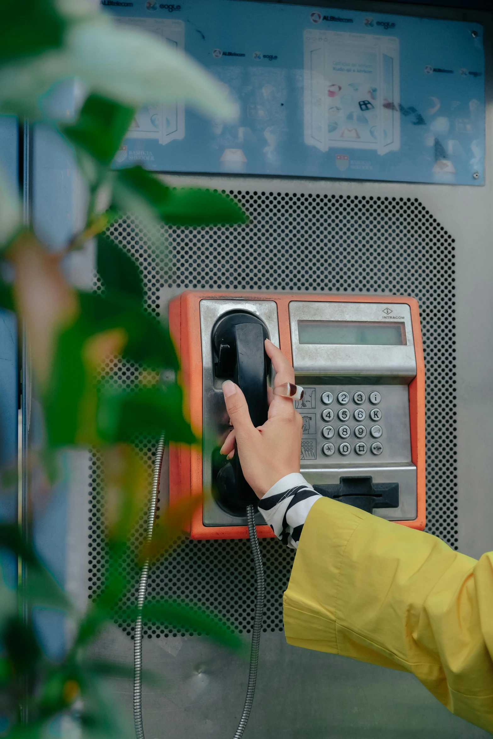 the person is using the telephone as they check it