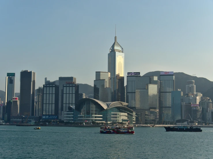 a boat in the water in front of a large city