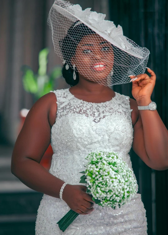 a bride in a white gown holding a bouquet of flowers