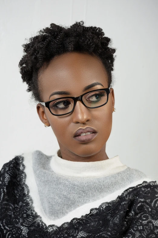 woman in glasses stares directly at camera while standing