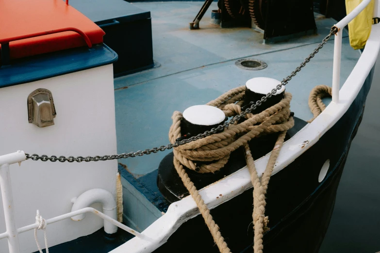 rope tied to the bow of a ship with two smaller white caps