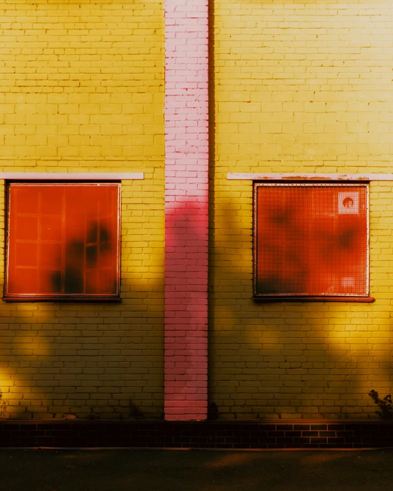 the shadow of the building is cast on the brick