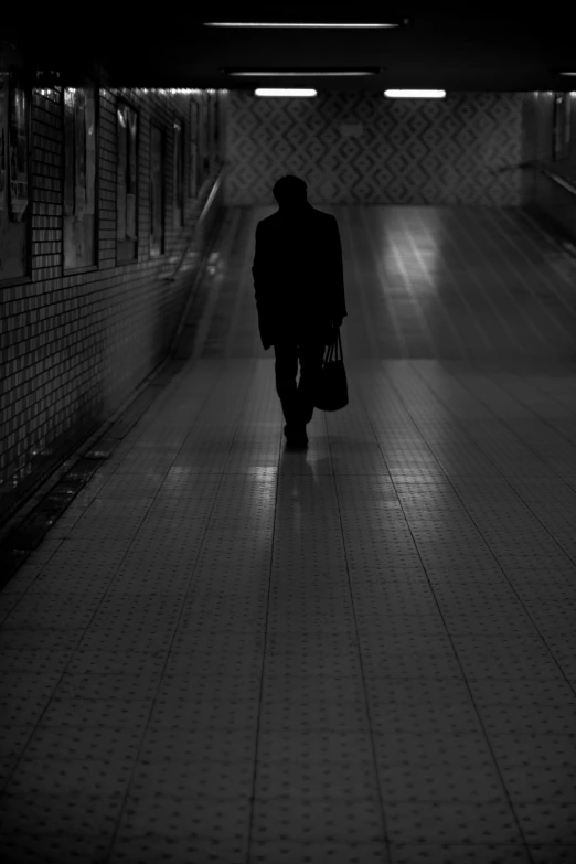 a person walking away from soing in the dark