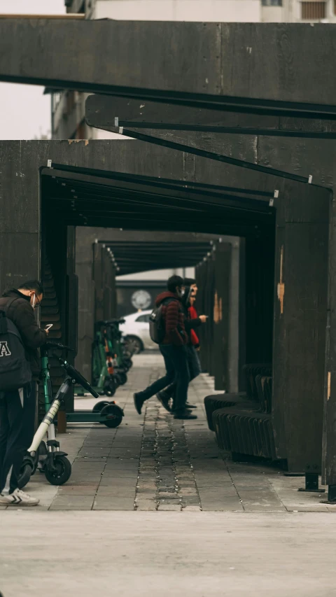 there are two people walking under a bridge