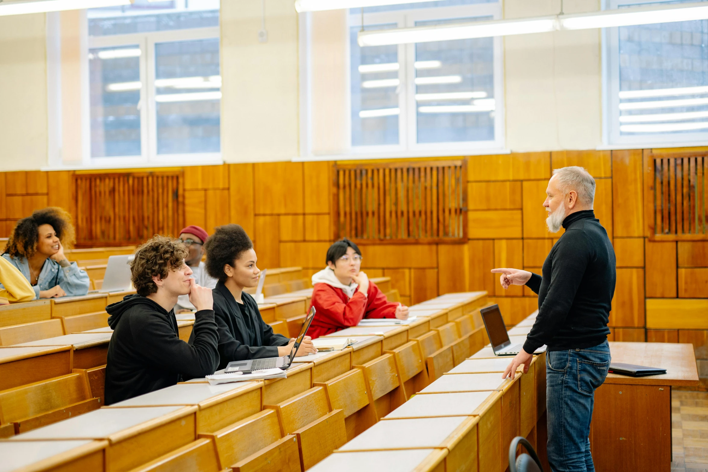 a man speaks to students at a lecture hall