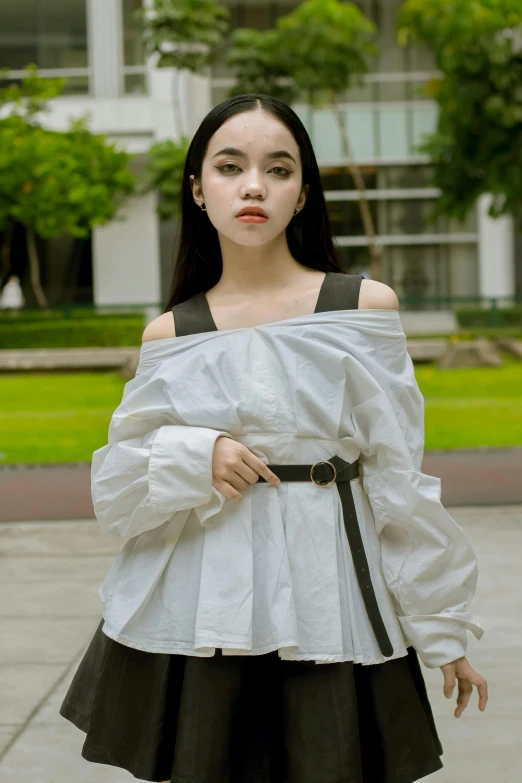 a girl in a white shirt and black skirt