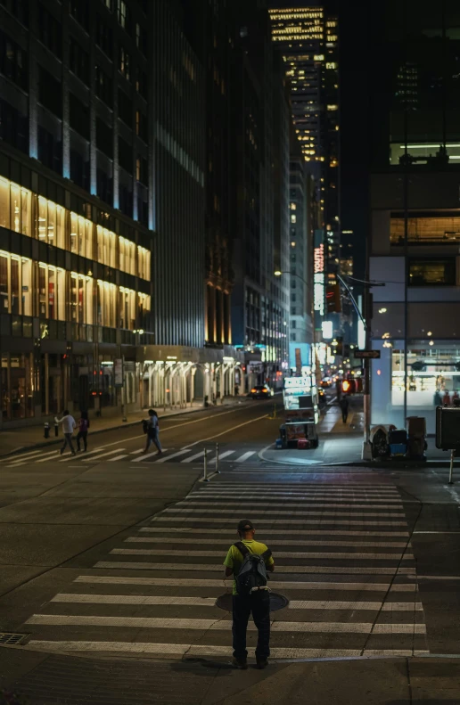 an intersection with a man standing at it