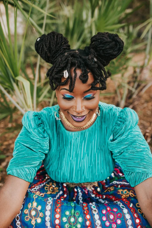 a person sitting down with some makeup on