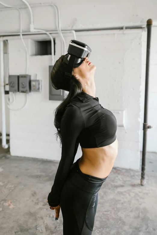 woman wearing a black top looking up with her head on the wall