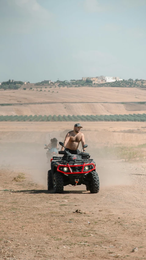 a man is riding a four - wheeler in the middle of the desert