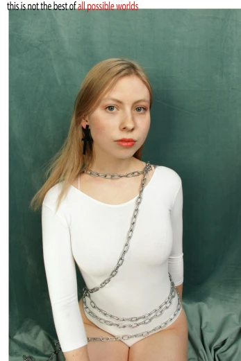 a blonde girl sitting in a shirt and chain