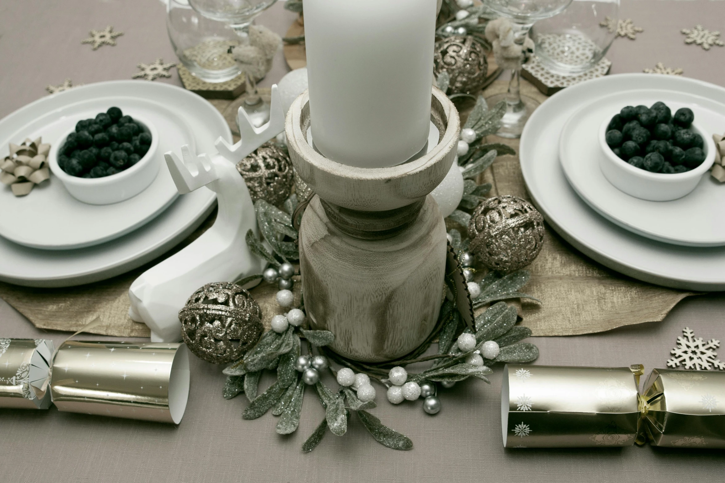 a fancy place setting with candle, plates and silverware