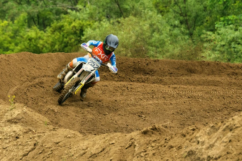 a person riding a motor bike on a dirt track