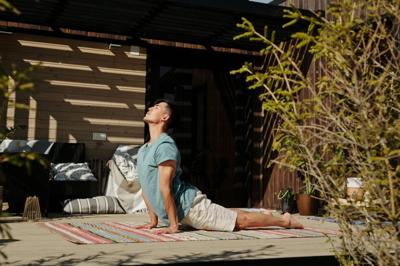 man sitting on an outdoor mat doing yoga