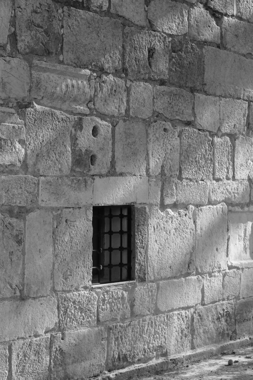 a stone wall with a window in it