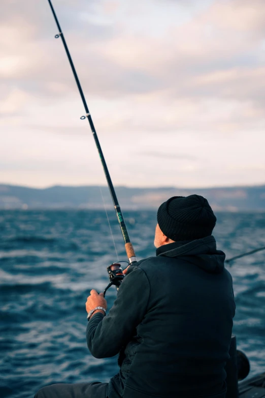 a man fishing from a boat in the ocean