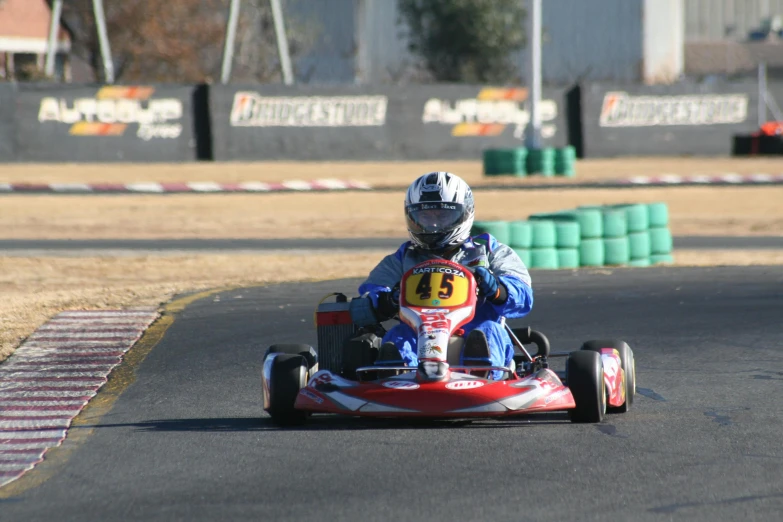 the small child is riding on the go kart