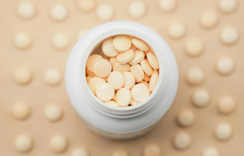 a white container full of vitamin capsules