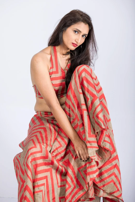 woman in orange and red saree posing for the camera