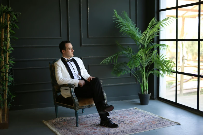 a man sitting on a chair in a room