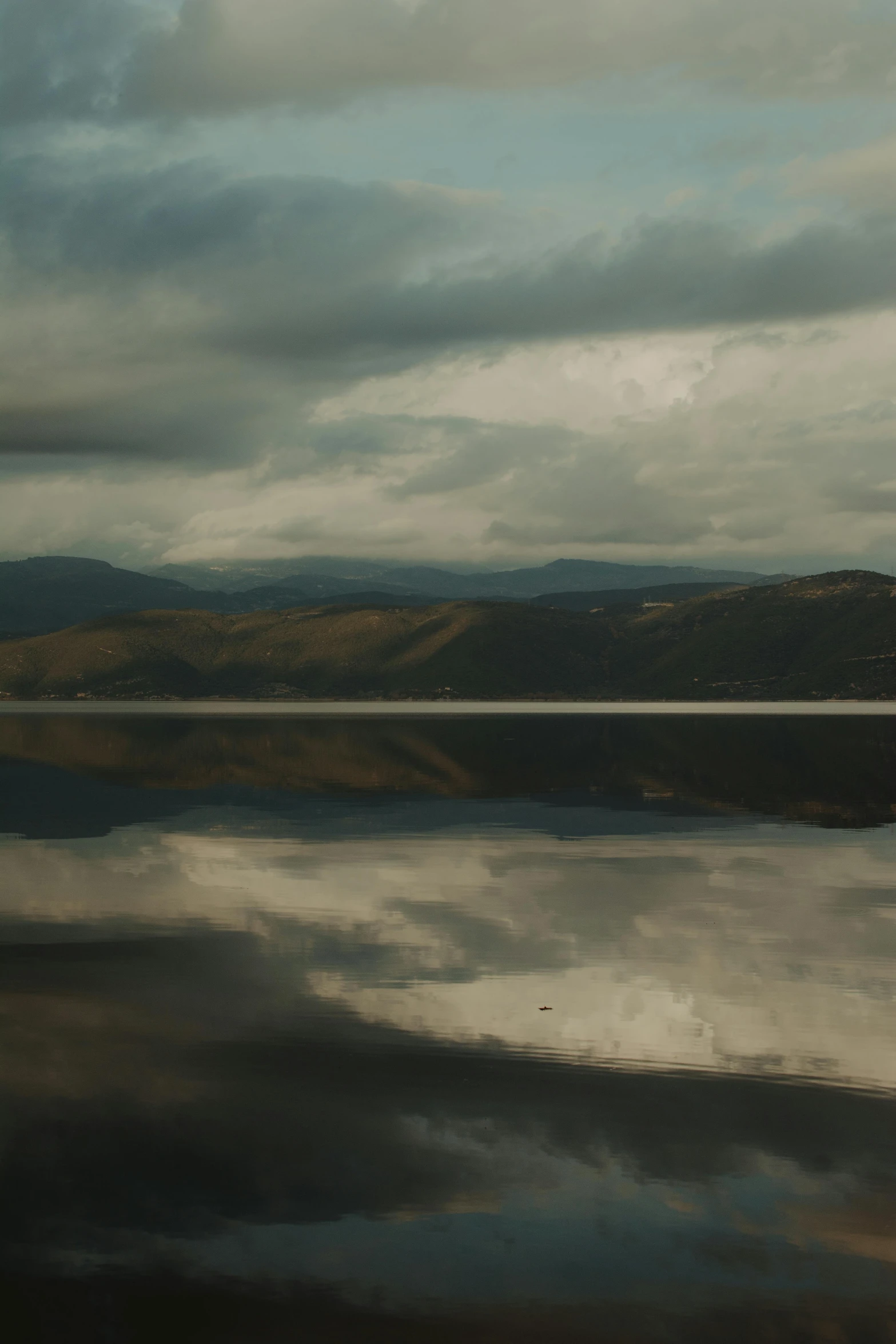 the land below is covered in clouds and reflections