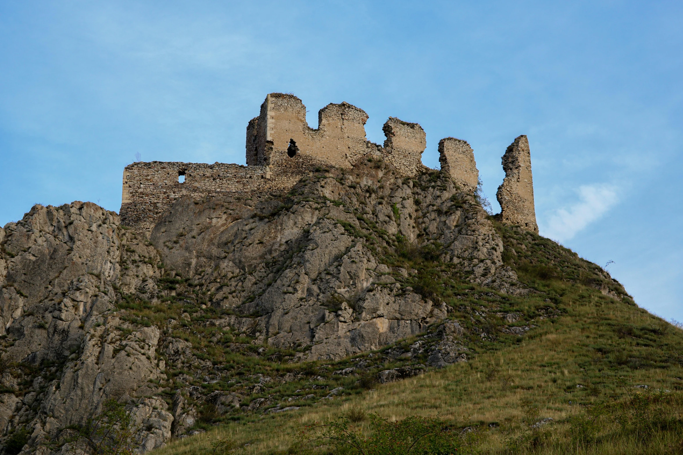 a stone castle sitting on the side of a steeple