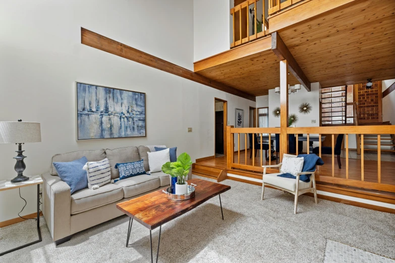 the wooden railing on the side of the home gives some character to the sitting area