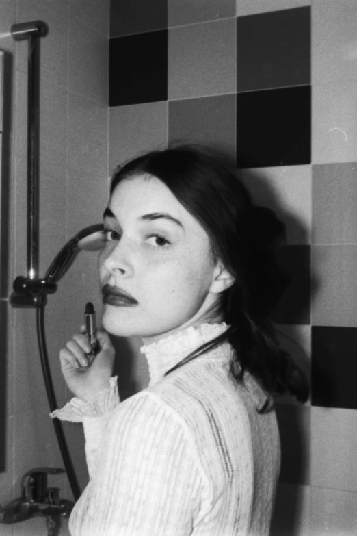 a young woman in her 30's brushing her teeth