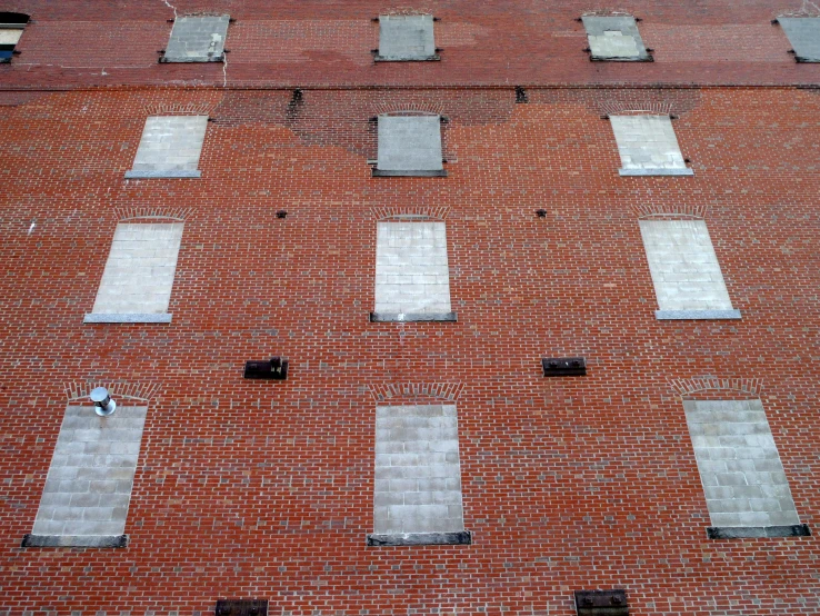 there are two men standing next to a building with three windows