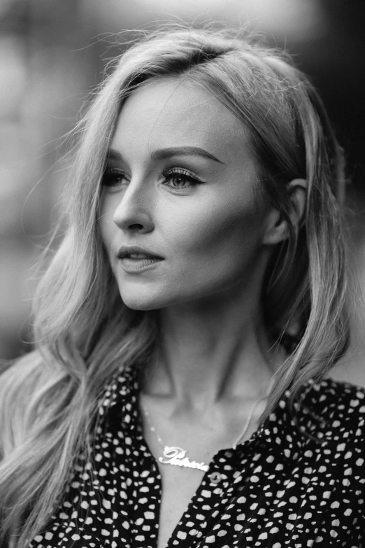 a beautiful blond woman in black and white posing for a po