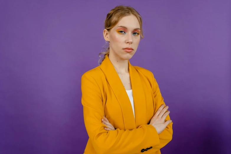 the woman is wearing a mustard coat and orange hair