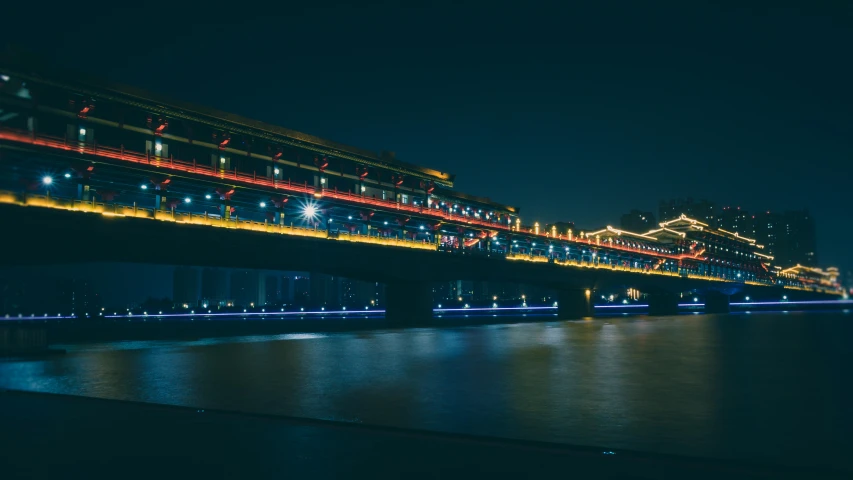 a city bridge lit up at night by lights