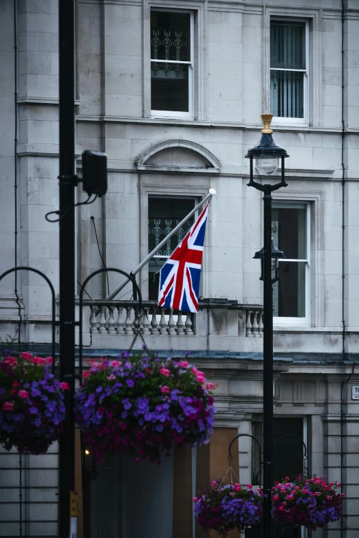 a union jack flag hanging over a balcony in london