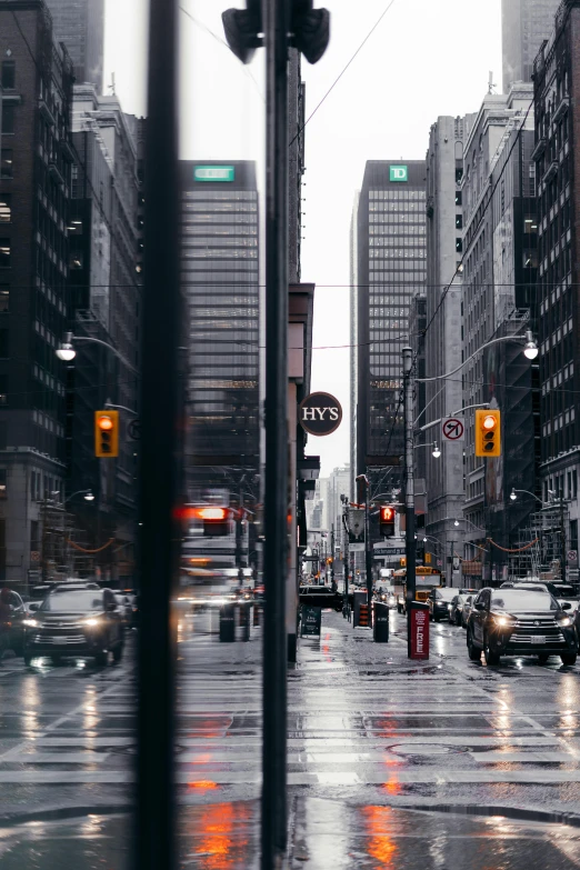 rainy city street with red lights and traffic