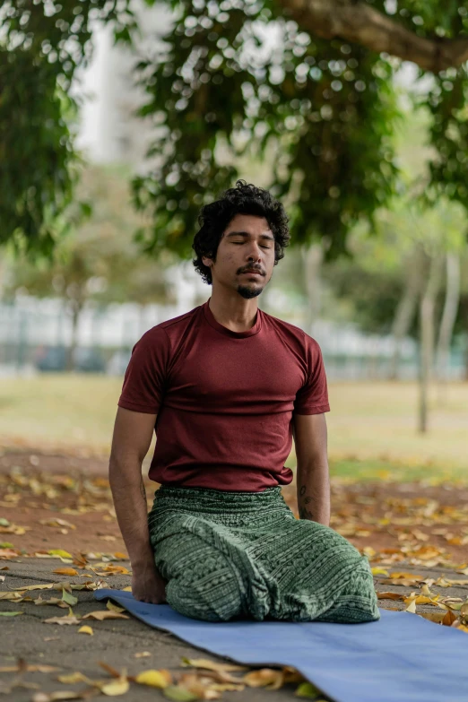 a man sitting on the ground with a towel in his hands