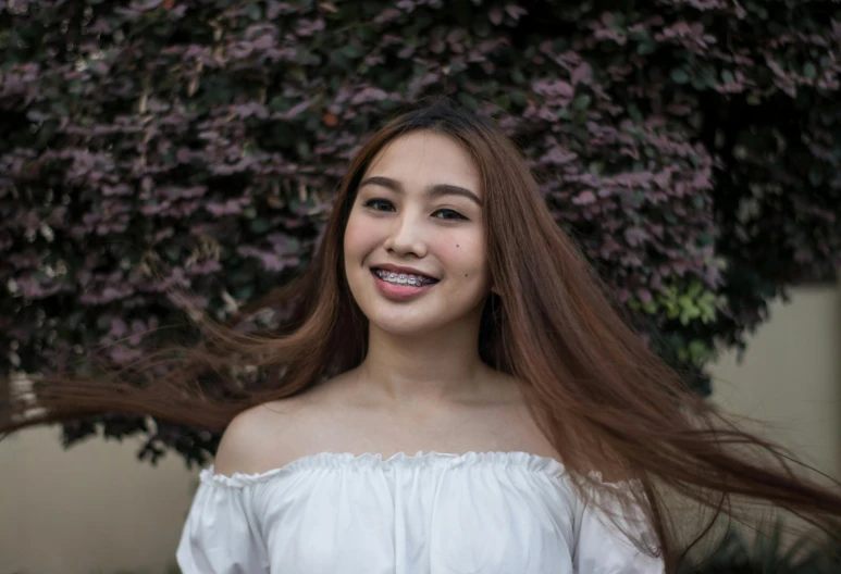 a young woman with long, straight hair smiles at the camera