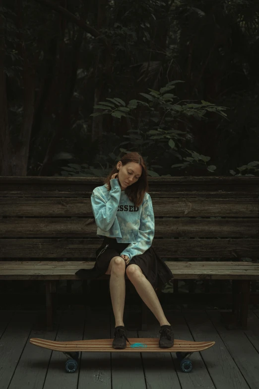 a woman sitting on a wooden bench while using her phone