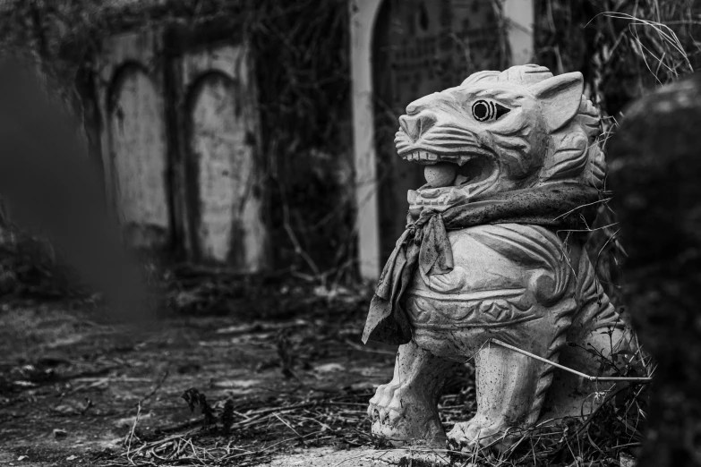 black and white po of a statue of a lion in a yard