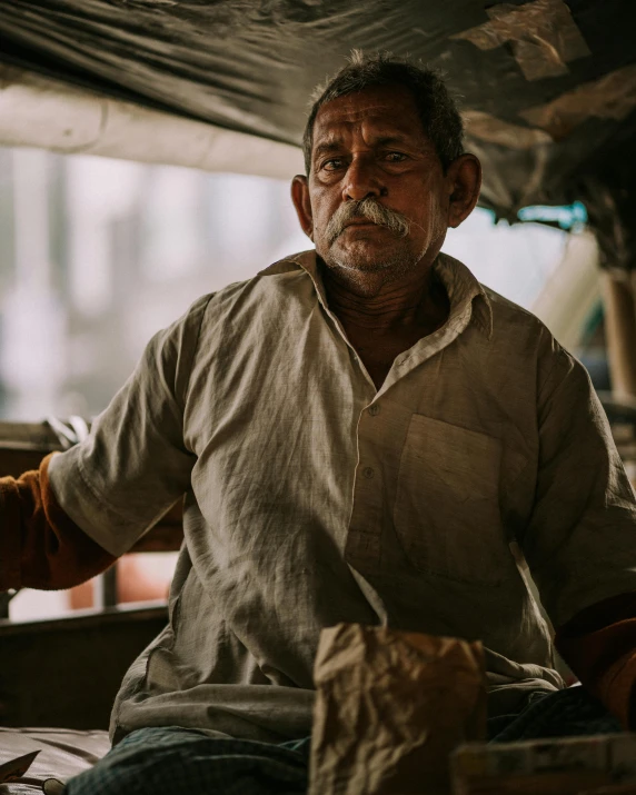 an old man wearing a large beard and wearing an apron