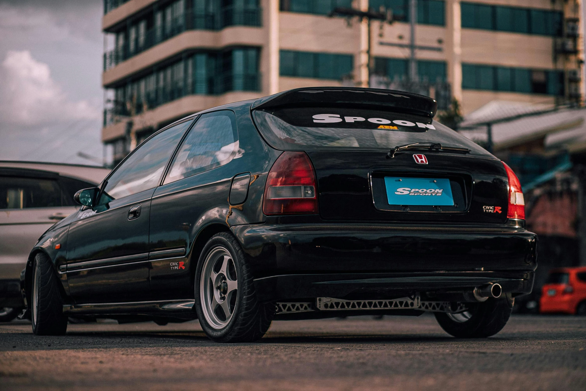 a black car that is sitting on the street