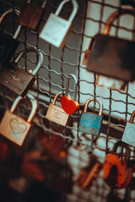 two locks are attached to the door of a fence