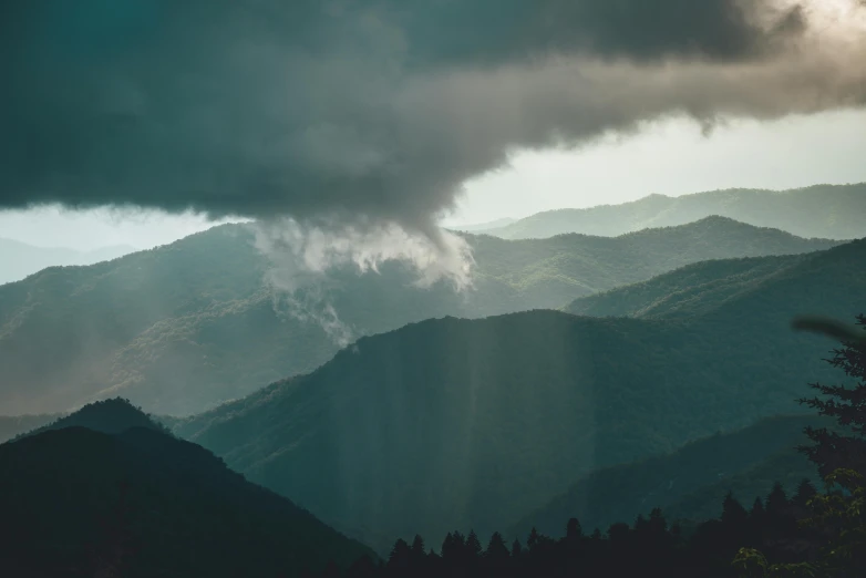 an image of dark stormy clouds in the mountains