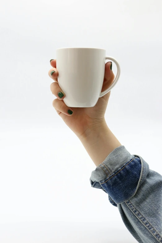 woman holding coffee mug up in the air