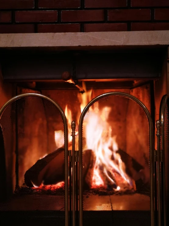 an open fire burns in a brick fireplace