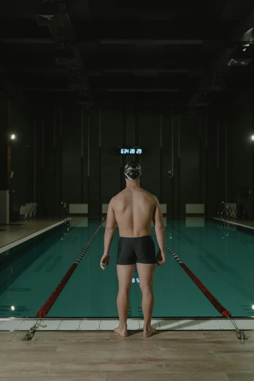 a man standing in front of an empty swimming pool