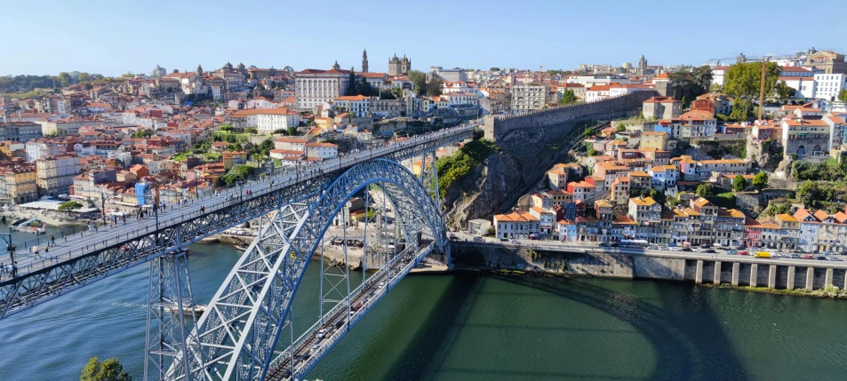 the blue steel bridge crosses over water in a town